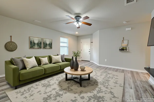 a large kitchen with stainless steel appliances granite countertop a stove top oven a refrigerator and a sink