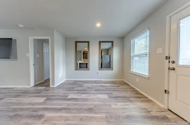 wooden floor in an empty room with a window