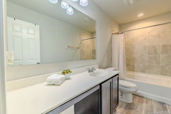 a bedroom with a bed a dresser and a book shelf