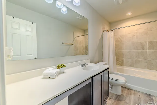 a bedroom with a bed a dresser and a book shelf