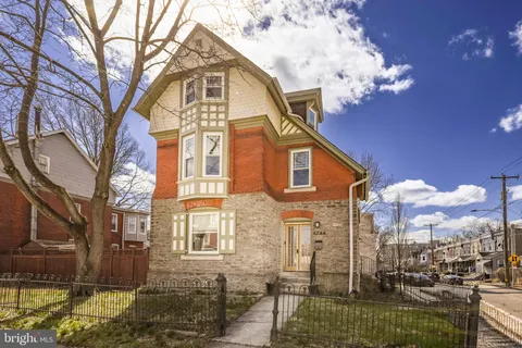 a view of a brick house with a yard