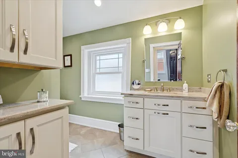 a bathroom with a sink vanity and mirror