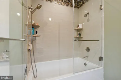 a bathroom with a bath tub and shower