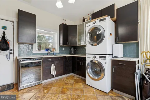 a kitchen with a washer and dryer in it