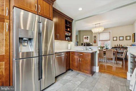 a kitchen with stainless steel appliances granite countertop a refrigerator and a sink