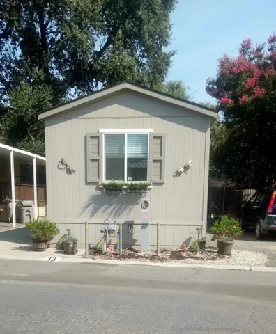 a front view of a house with a garden