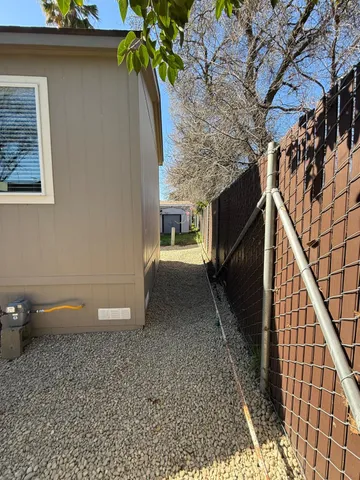 a large kitchen with kitchen island a sink a stove a refrigerator and white cabinets