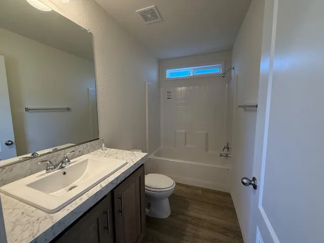 a view of a patio with a table and chairs