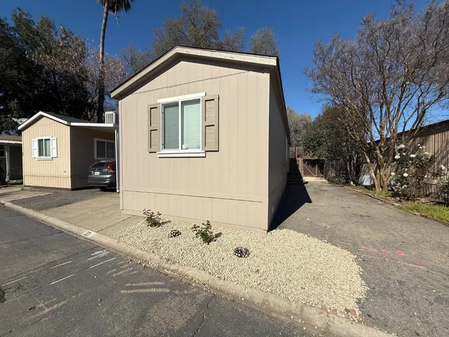 a bathroom with a granite countertop sink toilet a large mirror and shower