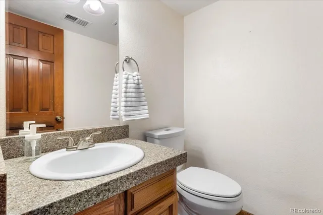 a view of a kitchen with a sink and a refrigerator