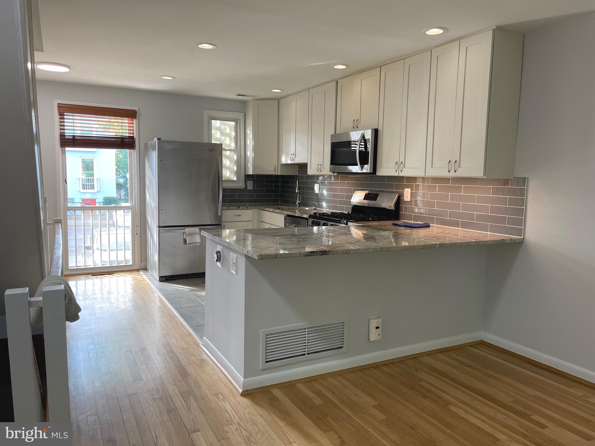 108 G Street Southwest, Unit 105 Washington, DC 20024 - Photo 13 of 52 a kitchen with stainless steel appliances granite countertop a refrigerator sink and microwave
