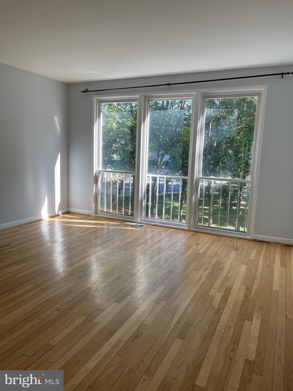 108 G Street Southwest, Unit 105 Washington, DC 20024 - Photo 9 of 52 wooden floor in an empty room with a window