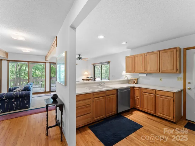 a kitchen with stainless steel appliances granite countertop sink stove top oven and cabinets