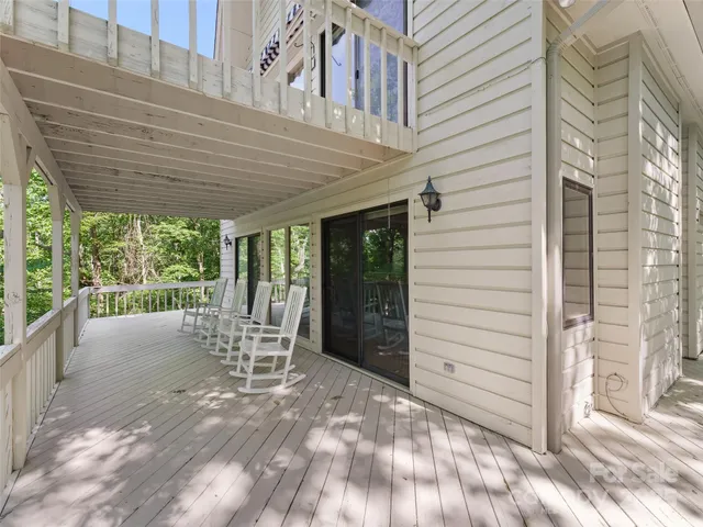 a view of a patio with a table and chairs and wooden fence