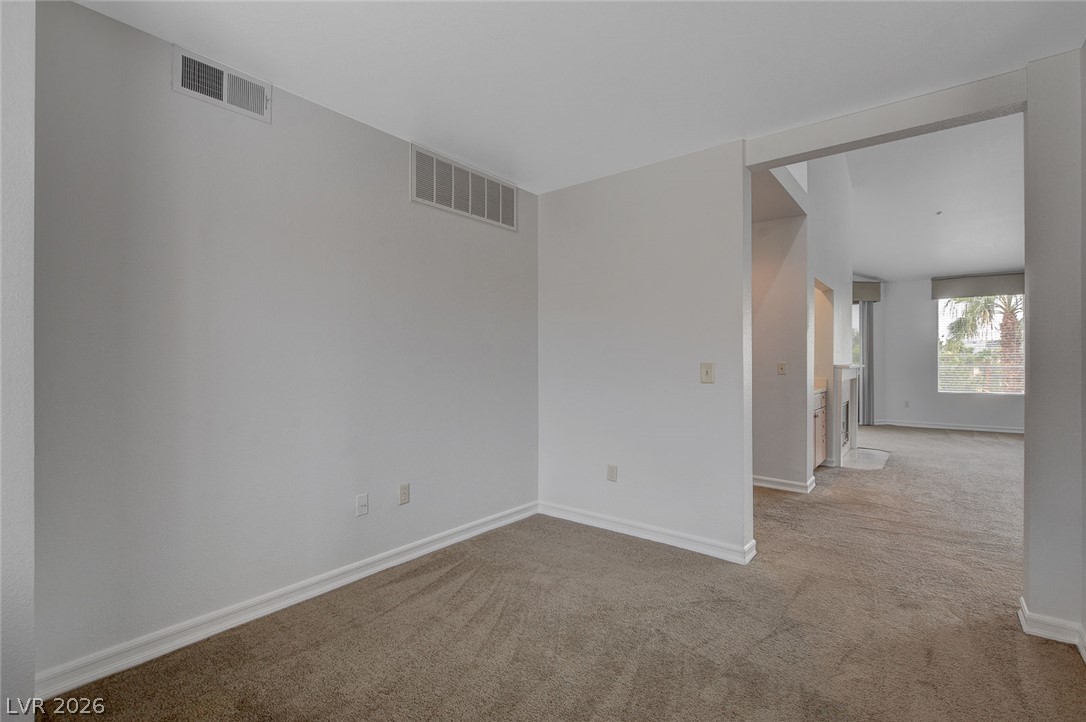 230 East Flamingo Road, Unit 404 Las Vegas, NV 89169 - Photo 9 of 34 Plush carpeting flows through this versatile interior space opening to the main living area.