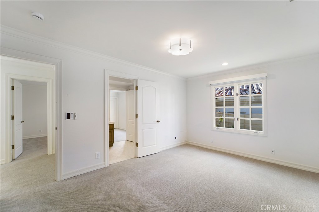 82 Ritz Cove Drive Dana Point, CA 92629 - Photo 36 of 48 an empty room with windows and chandelier fan