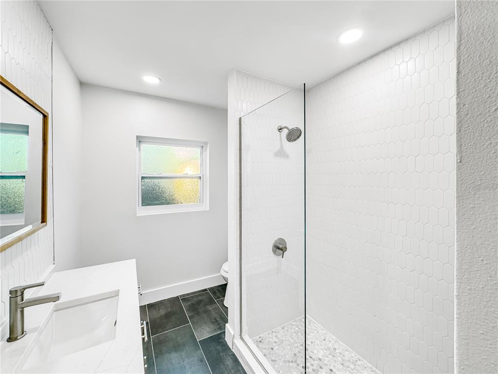 13739 Coco Avenue Hudson, FL 34667 - Photo 11 of 25 a bathroom with a tub and shower