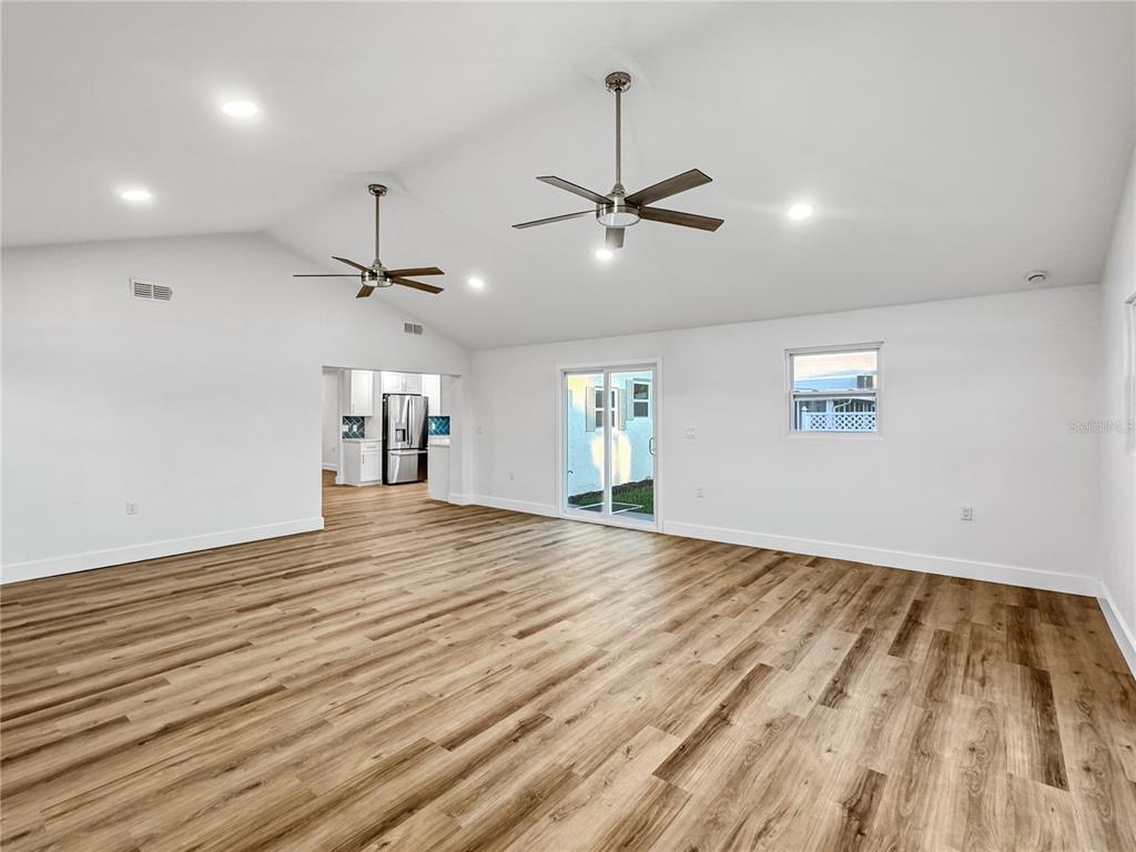13739 Coco Avenue Hudson, FL 34667 - Photo 18 of 25 a view of empty room with wooden floor and ceiling fan