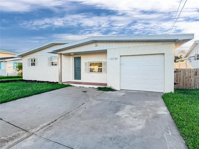 a view of a house with a yard and garage