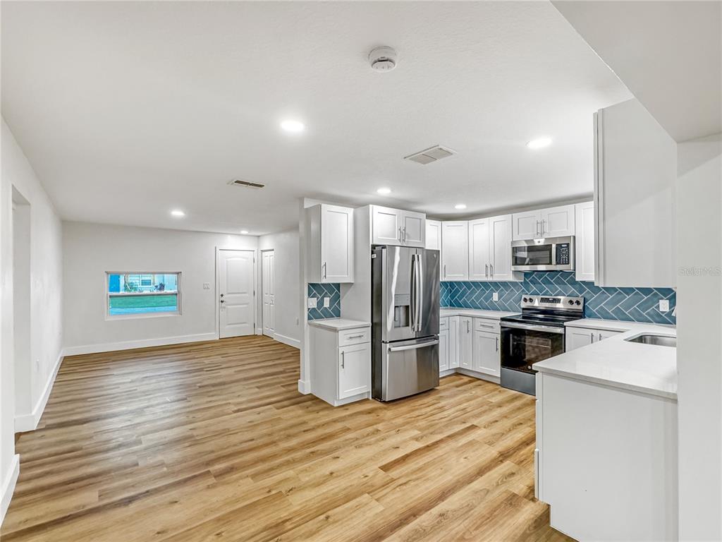 13739 Coco Avenue Hudson, FL 34667 - Photo 4 of 25 a kitchen with refrigerator and microwave