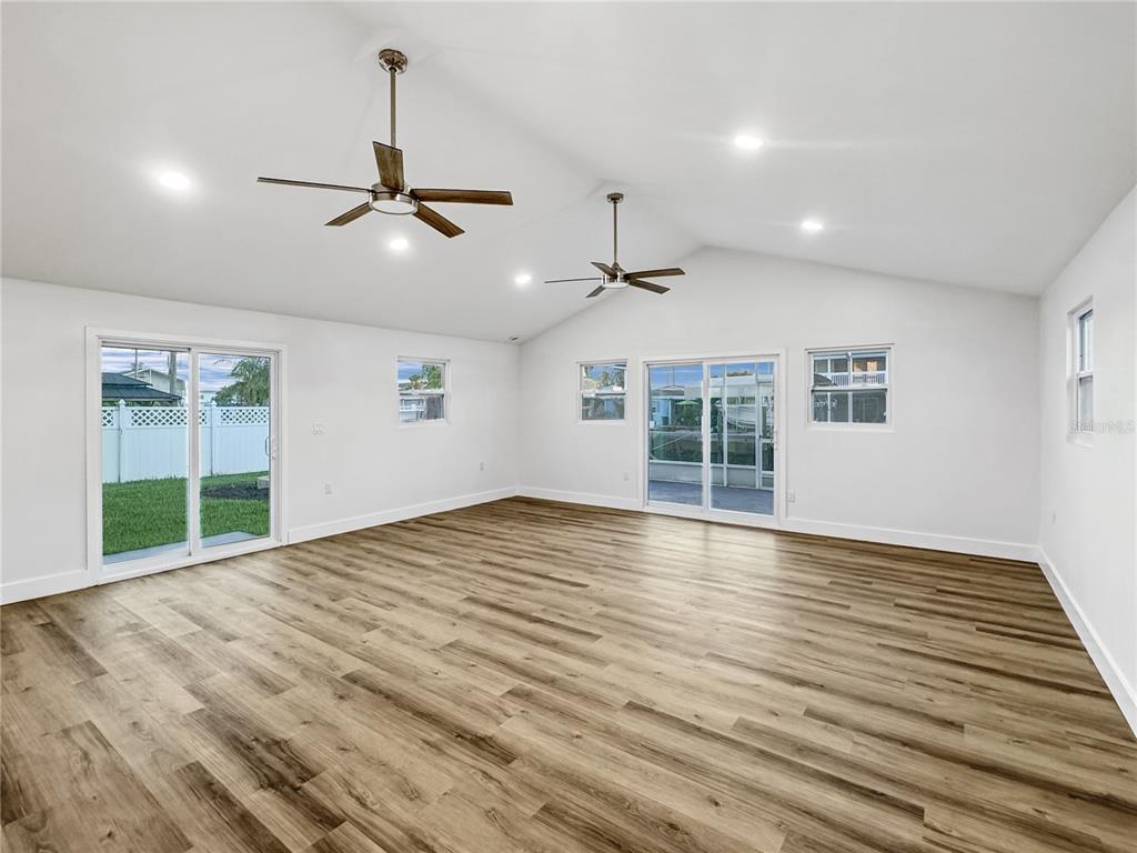 13739 Coco Avenue Hudson, FL 34667 - Photo 8 of 25 a view of an empty room with a window and wooden floor