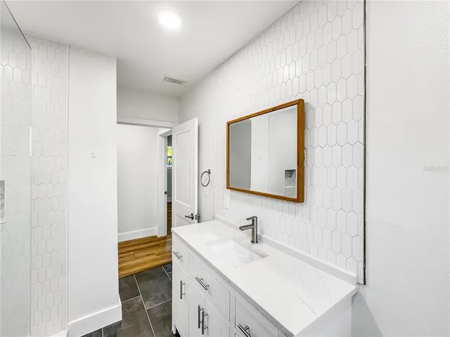 a bathroom with a sink a mirror and a toilet