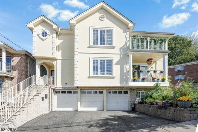 a front view of a house with a garden