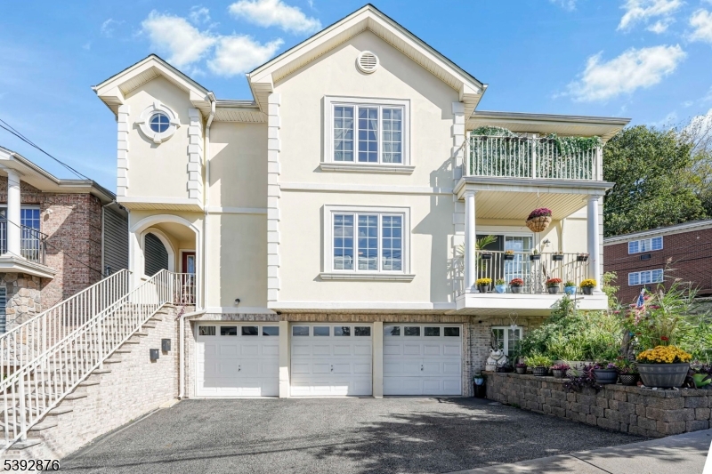 615 Prospect Avenue Fairview, NJ 07022 - Photo 1 of 18 a front view of a house with a garden