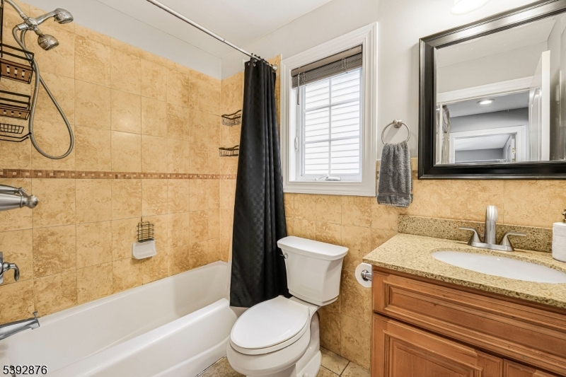 615 Prospect Avenue Fairview, NJ 07022 - Photo 11 of 18 a bathroom with a granite countertop sink toilet and shower