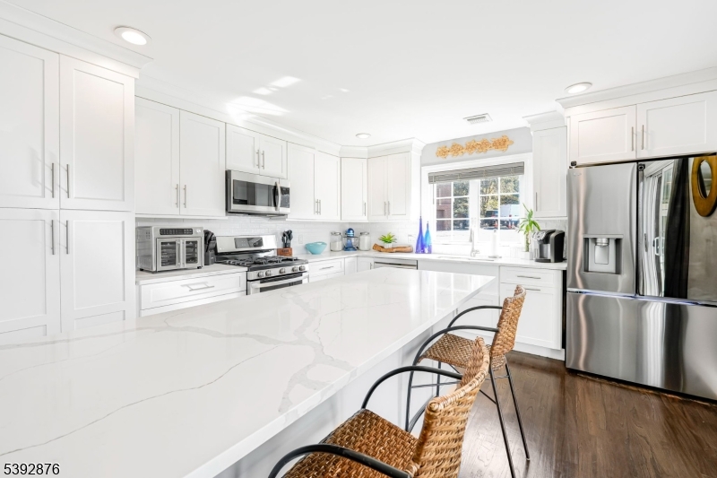 615 Prospect Avenue Fairview, NJ 07022 - Photo 7 of 18 a kitchen with stainless steel appliances granite countertop a refrigerator and a stove top oven
