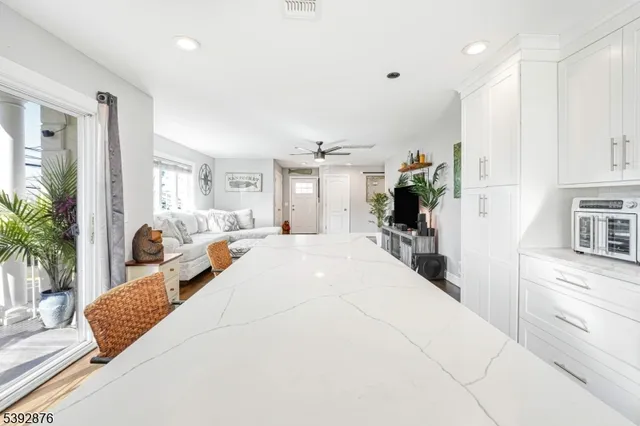 a large white bedroom with a large bed and a large window