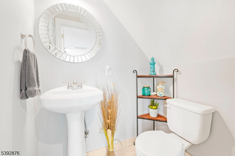 615 Prospect Avenue Fairview, NJ 07022 - Photo 9 of 18 a bathroom with a sink a toilet and a mirror