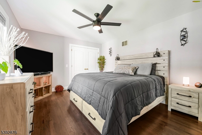 615 Prospect Avenue Fairview, NJ 07022 - Photo 10 of 18 a bedroom with a bed and a flat screen tv