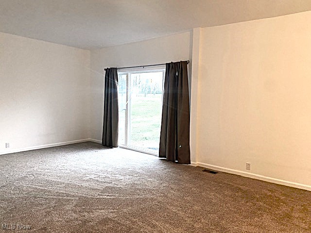 71056 Morristown Flushing Road Flushing, OH 43977 - Photo 7 of 15 Spare room with dark colored carpet and baseboards