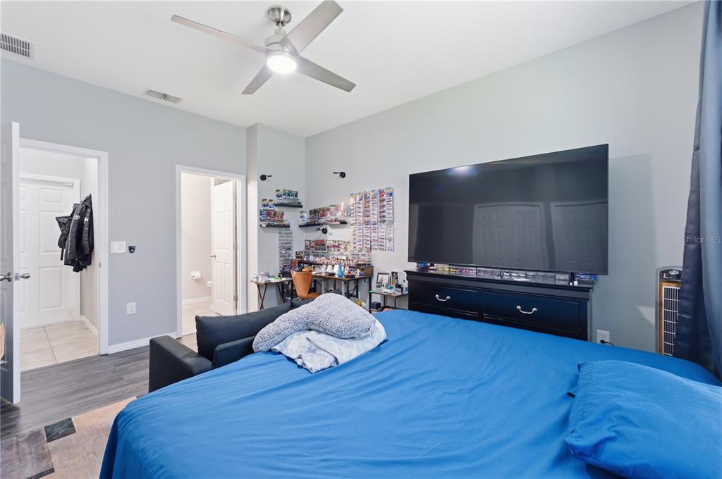 4810 Poolside Drive St. Cloud, FL 34769 - Photo 11 of 26 a living room with furniture and a flat screen tv