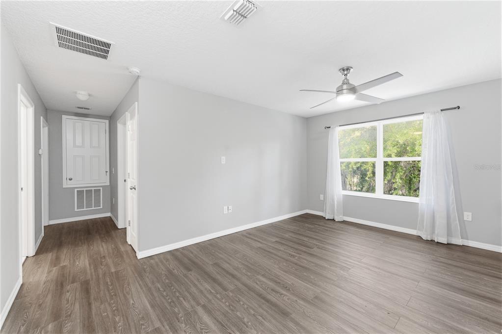 4810 Poolside Drive St. Cloud, FL 34769 - Photo 14 of 26 a view of an empty room with wooden floor and a window
