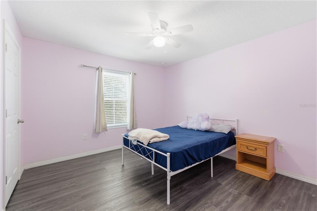 4810 Poolside Drive St. Cloud, FL 34769 - Photo 16 of 26 a bedroom with a bed and a dresser in it