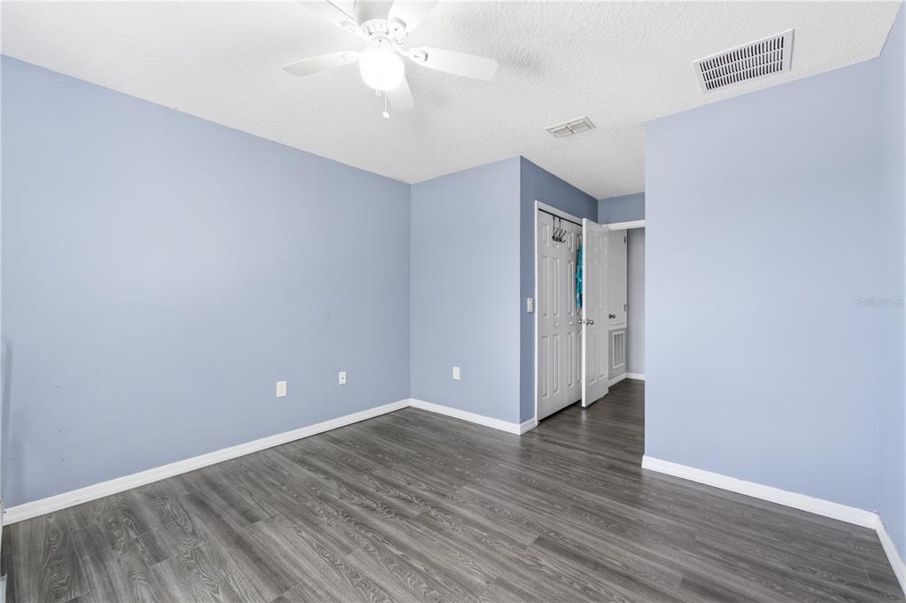 4810 Poolside Drive St. Cloud, FL 34769 - Photo 17 of 26 a view of an empty room with wooden floor