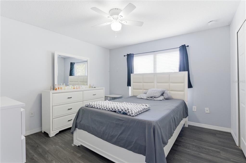 4810 Poolside Drive St. Cloud, FL 34769 - Photo 18 of 26 a bedroom with a bed and a dresser