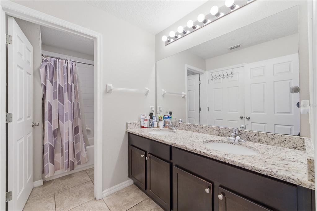 4810 Poolside Drive St. Cloud, FL 34769 - Photo 20 of 26 a bathroom with a sink double vanity and a mirror