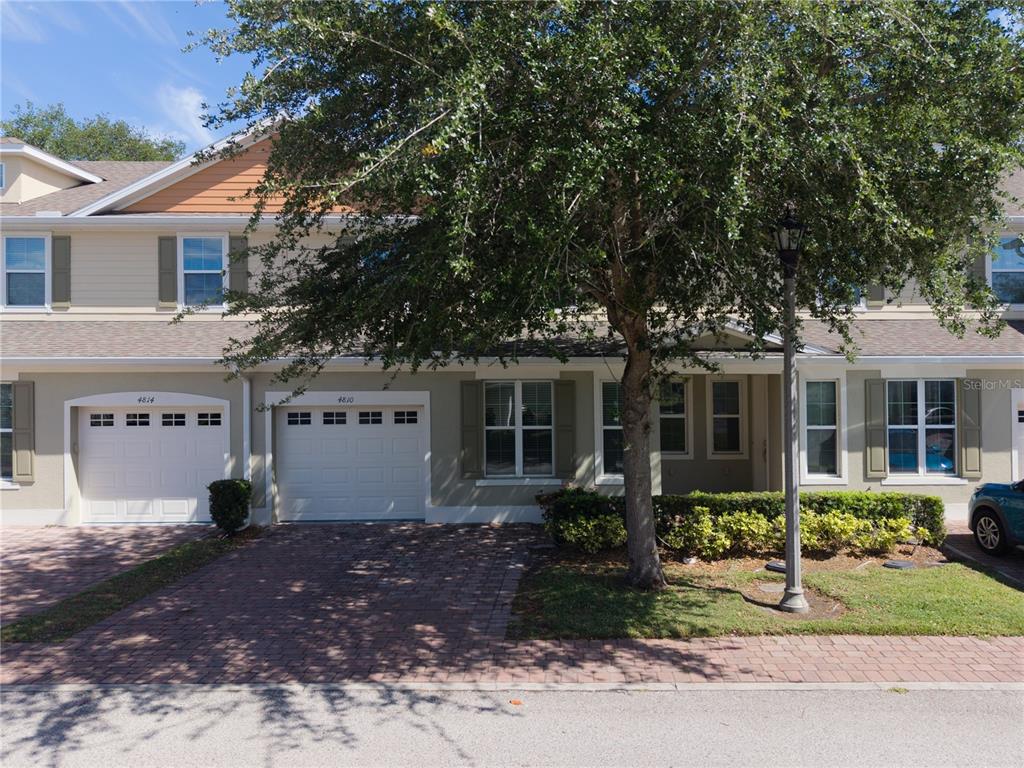 4810 Poolside Drive St. Cloud, FL 34769 - Photo 2 of 26 a front view of a house with a garden and porch