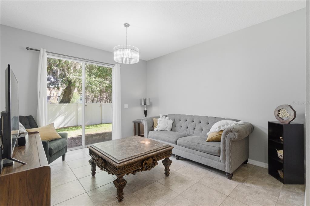 4810 Poolside Drive St. Cloud, FL 34769 - Photo 4 of 26 a living room with furniture a flat screen tv and a large window