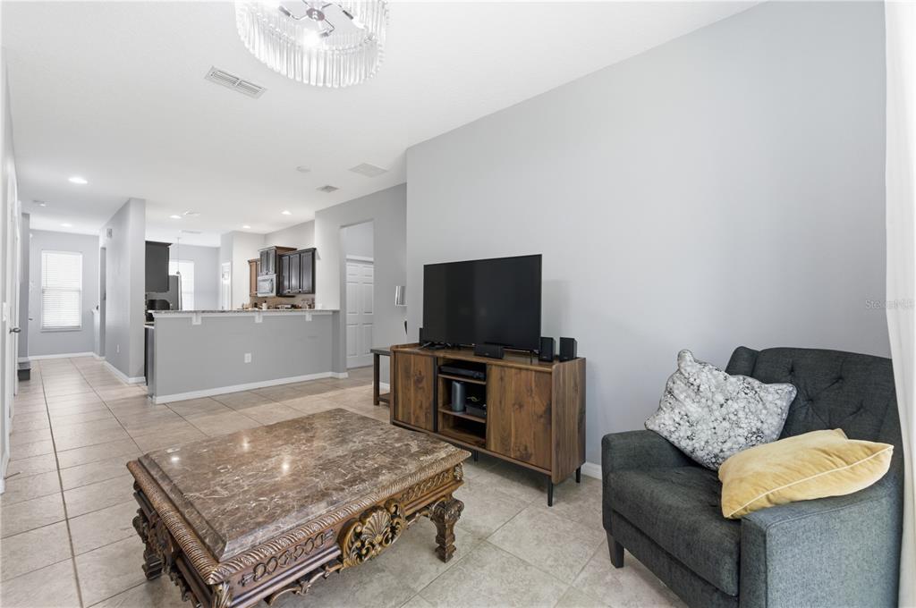 4810 Poolside Drive St. Cloud, FL 34769 - Photo 5 of 26 a living room with furniture and a flat screen tv