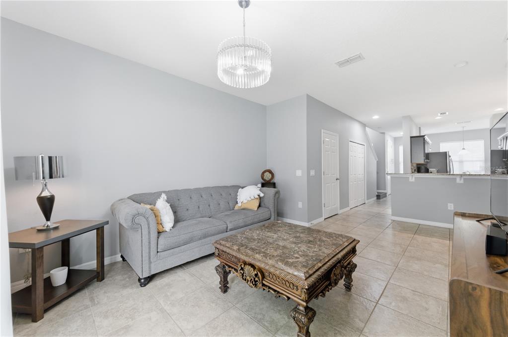 4810 Poolside Drive St. Cloud, FL 34769 - Photo 6 of 26 a living room with furniture and a chandelier