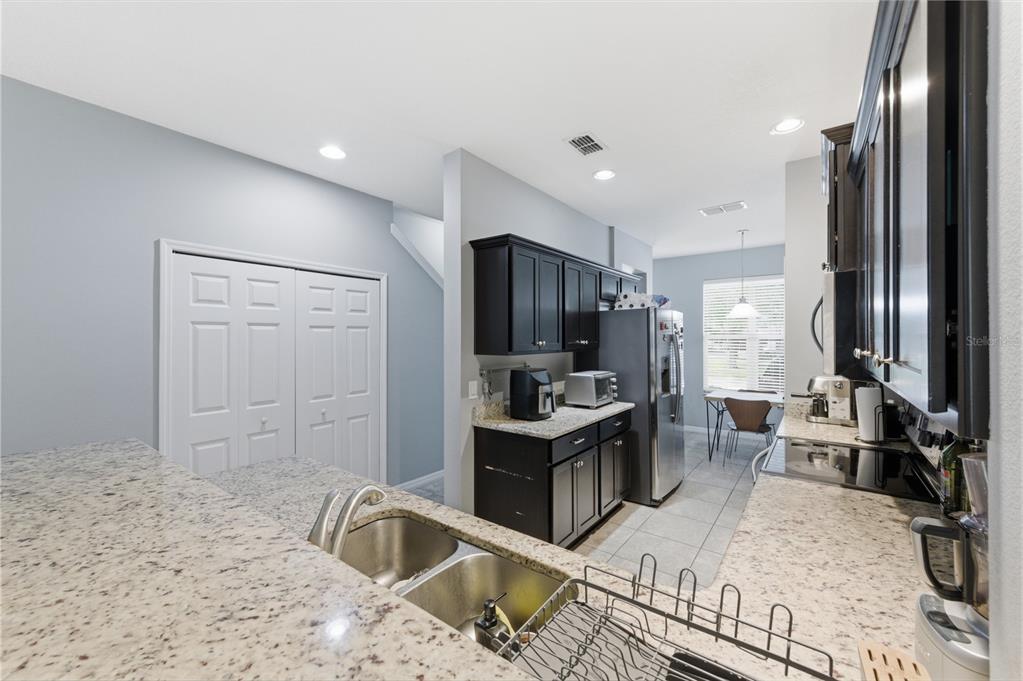 4810 Poolside Drive St. Cloud, FL 34769 - Photo 8 of 26 a living room with stainless steel appliances granite countertop furniture a refrigerator and a sink