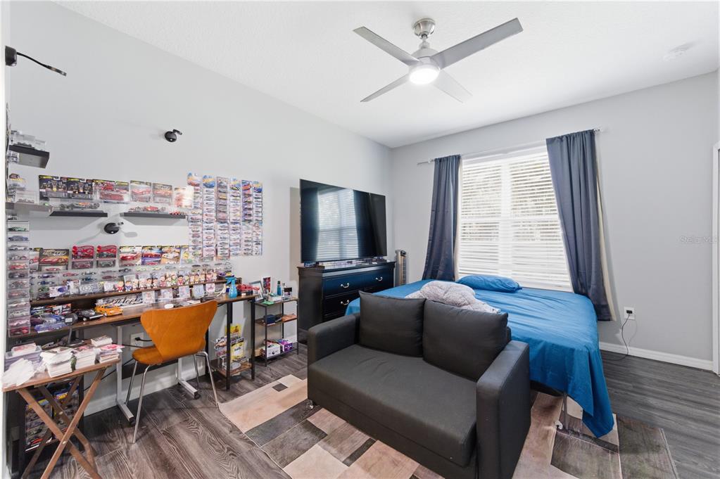 4810 Poolside Drive St. Cloud, FL 34769 - Photo 10 of 26 a living room with furniture and a flat screen tv