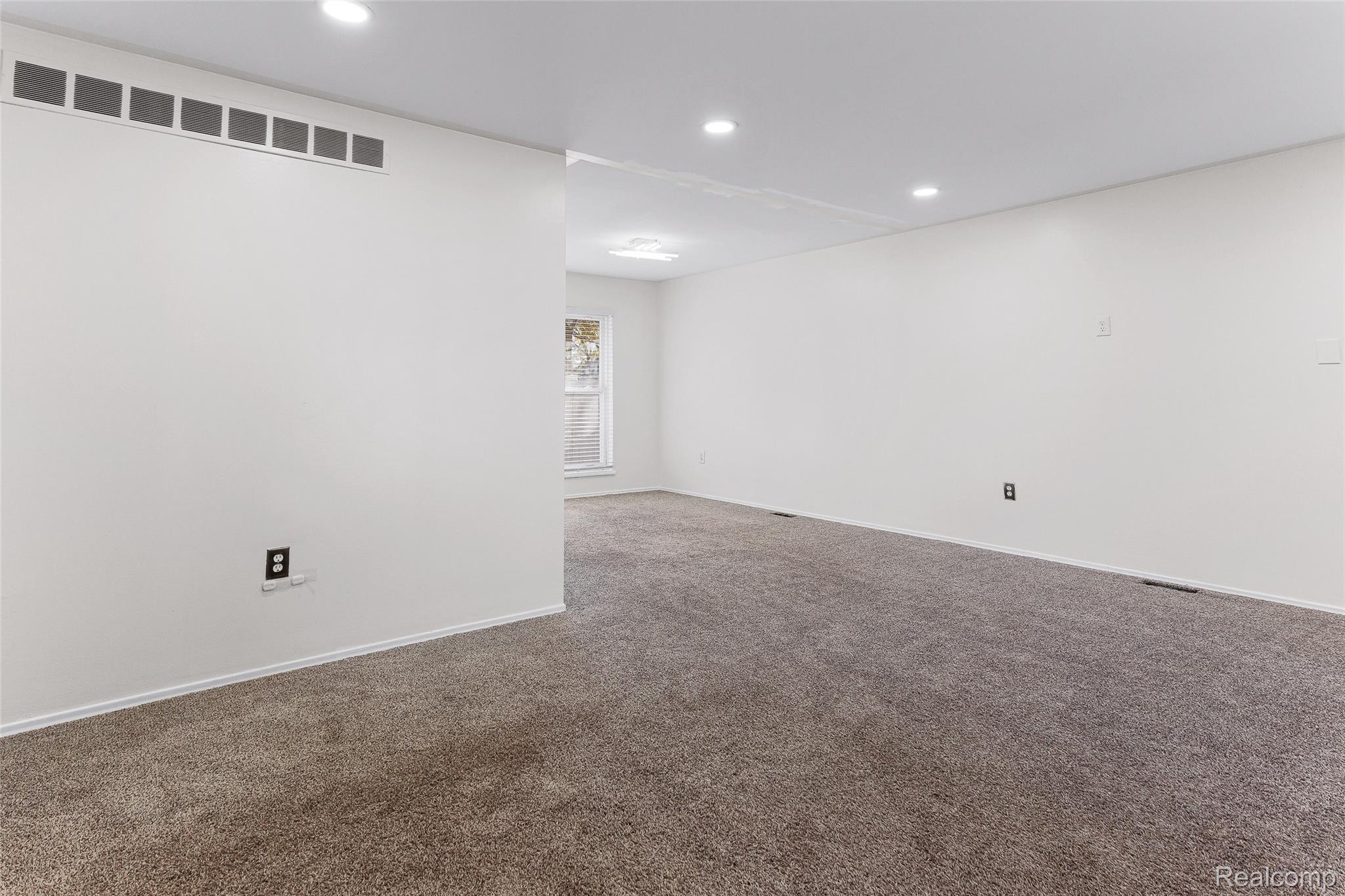 22582 Winfield Road Novi, MI 48375 - Photo 8 of 37 Spacious room featuring neutral carpeting, white walls, recessed lighting, and a white baseboard trim