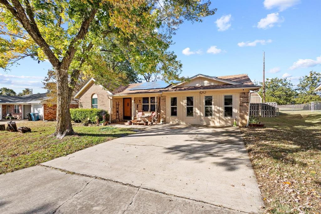 1417 Morrison Drive Denison, TX 75020 - Photo 2 of 30 Ranch-style home with solar panels and concrete driveway
