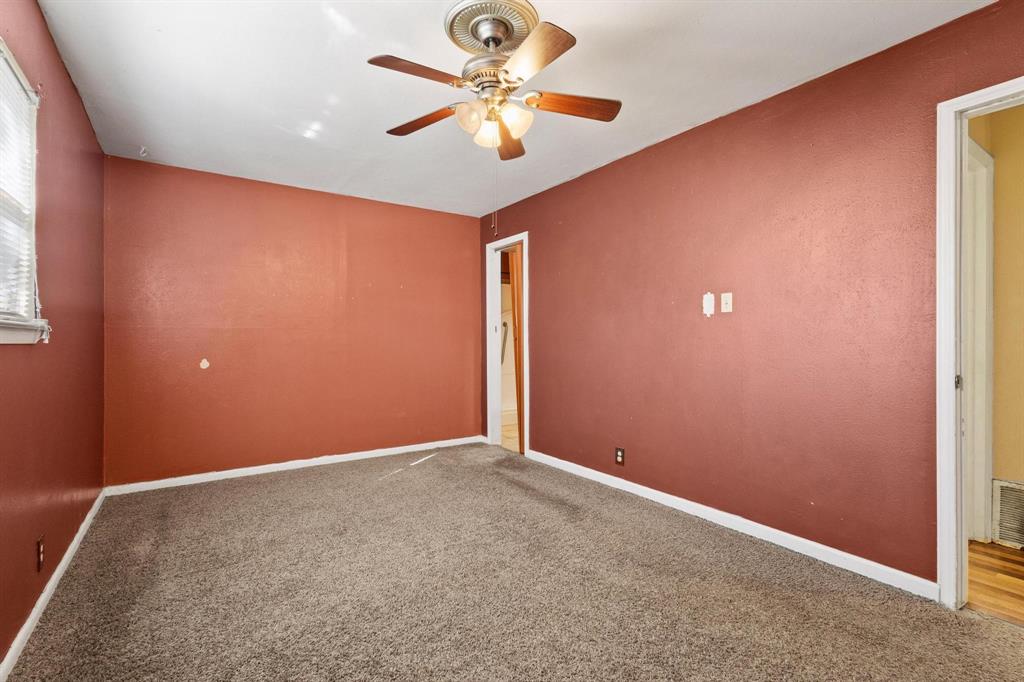 1417 Morrison Drive Denison, TX 75020 - Photo 23 of 30 Carpeted spare room featuring baseboards and a ceiling fan