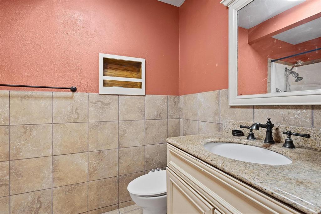 1417 Morrison Drive Denison, TX 75020 - Photo 25 of 30 Full bathroom with tile walls, vanity, a shower, and wainscoting